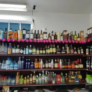 a shelf full of liquor bottles
