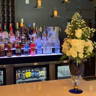 a vase of flowers on a bar