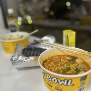 Buldak ramen with a bunch of vegetables and a side of kimbap