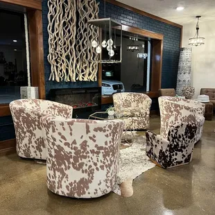 a living room with cow print furniture