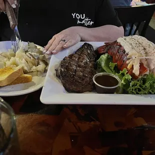 Rib eye with lobster Friday night special served with baked potato and salad with toast. Nicely done.