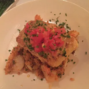 Special of dirty rice with shrimp and lobster topped with a crusted halibut