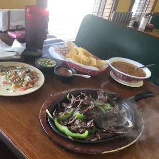 Fajitas dinner with a bowl of charro beans