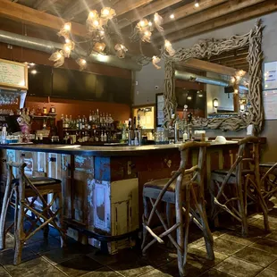 Beautiful full bar...that mirror is epic!