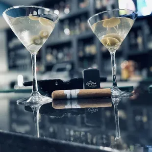 two martini glasses and a cigar
