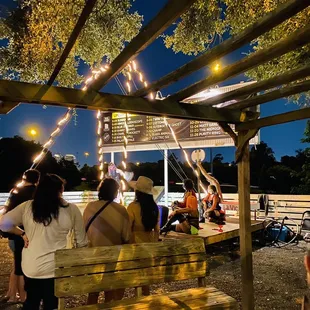 a group of people sitting at a picnic table