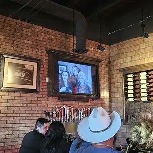 Lily Munster , Marilyn, &amp; Grandpa on video screen