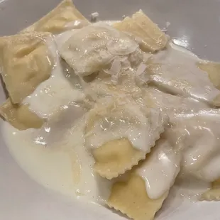 a white plate of ravioli