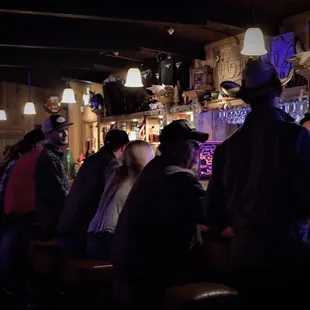 a group of people sitting at a bar