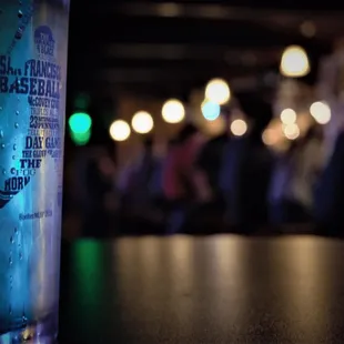 a glass of water on a bar counter