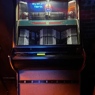 a juke box with a neon sign