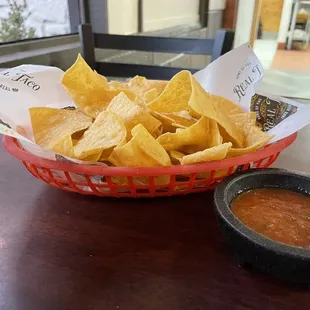 a bowl of chips and a bowl of salsa