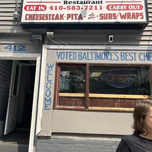 a woman standing in front of a restaurant