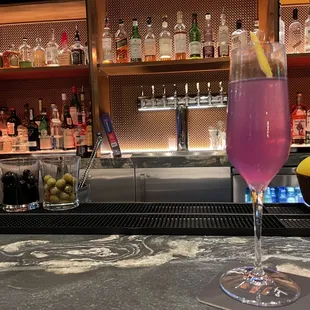 a glass of wine and a bowl of fruit