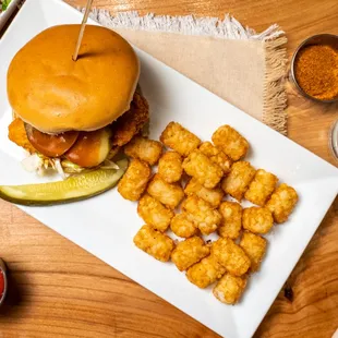 a burger and tater tots on a plate
