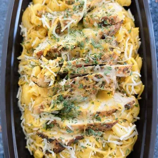 a dish of pasta with chicken and cheese