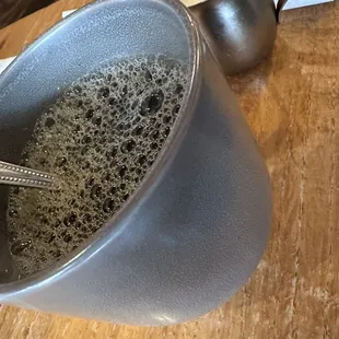 a cup of coffee with a spoon in it