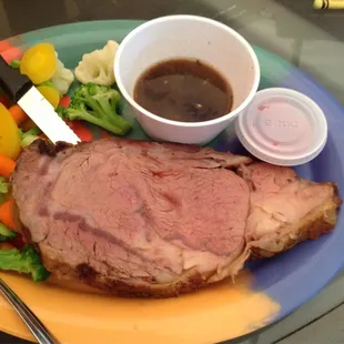 Prime rib (Fri &amp; Sat only) with colorful steamed veggies and au jus.