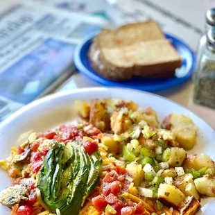 Garden scramble with avocado, country potatoes and wheat toast