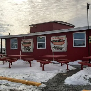 a red caboose covered in snow