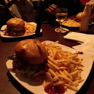 In front is the red fox Burger on the left is the barbecue bacon cheeseburger and the left bacon cheeseburger.