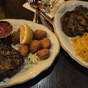 On right: ribeye steak and rice pilaf. On left: steak and scallops with baked potato.