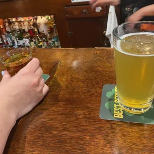 a person holding a glass of beer