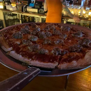 Small sausage pizza. Delicious! The bartender in this picture is awesome!