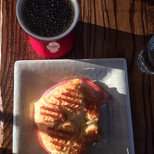 The breakfast croissant sandwich &amp; a house coffee.