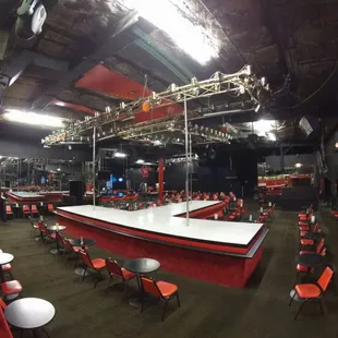 an empty stage with tables and chairs