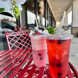 two drinks on a red bench