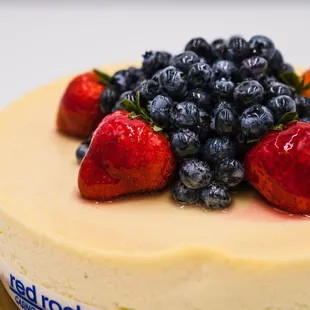 a cheesecake topped with strawberries and blueberries