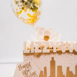 a cake with a balloon in the background