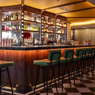 a bar with green chairs