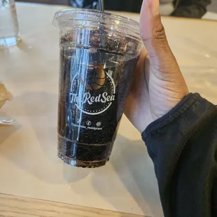 a hand holding a cup of coffee