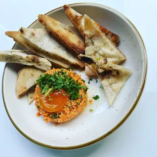 Carrot tartare with cured egg yolk and pita,