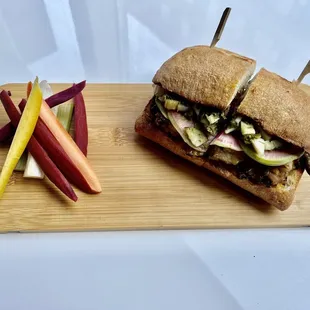 Pork belly sandwich with honey dijon, watermelon radish and pickles.