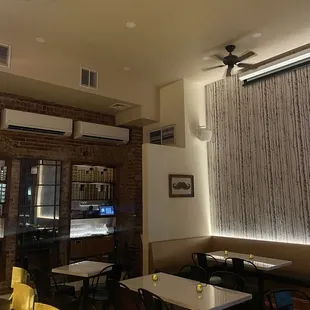 a dining room with yellow chairs