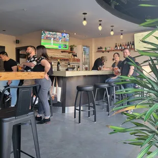 a group of people sitting at a bar