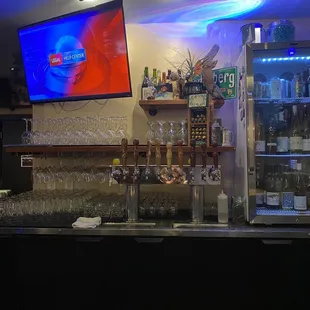 a bar with a television on the wall