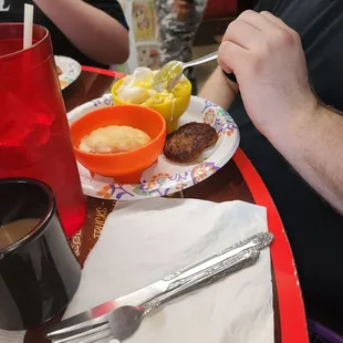 Poached eggs with grits and sausage and side of sausage gravy for the biscuit.