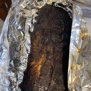 a piece of meat wrapped in tin foil