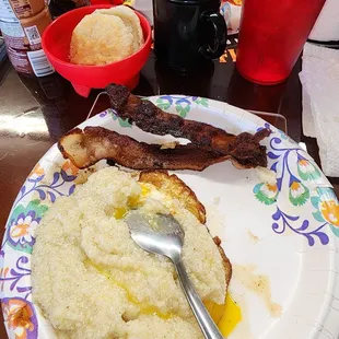 Grits and eggs with bacon (little over cooked)