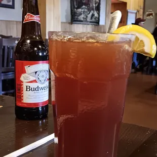 a glass of beer and a bottle of budwei
