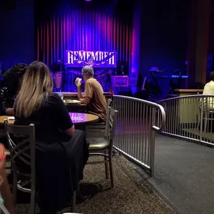 people sitting at tables with food and drinks