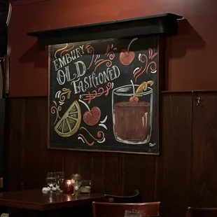 a chalkboard with a drink and a sign