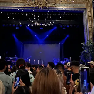 a crowd of people taking pictures of a stage