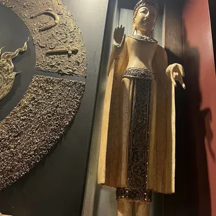 a statue of a man in a golden robe