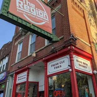 a storefront with a neon sign