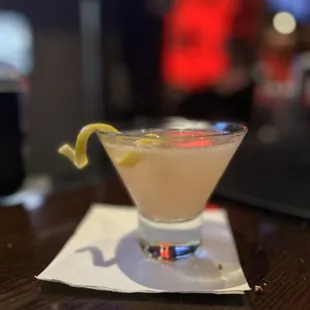 a martini with a lemon garnish